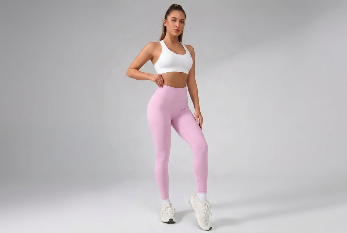 Woman wearing baby pink high-waisted leggings for an at-home squat-proof opacity test